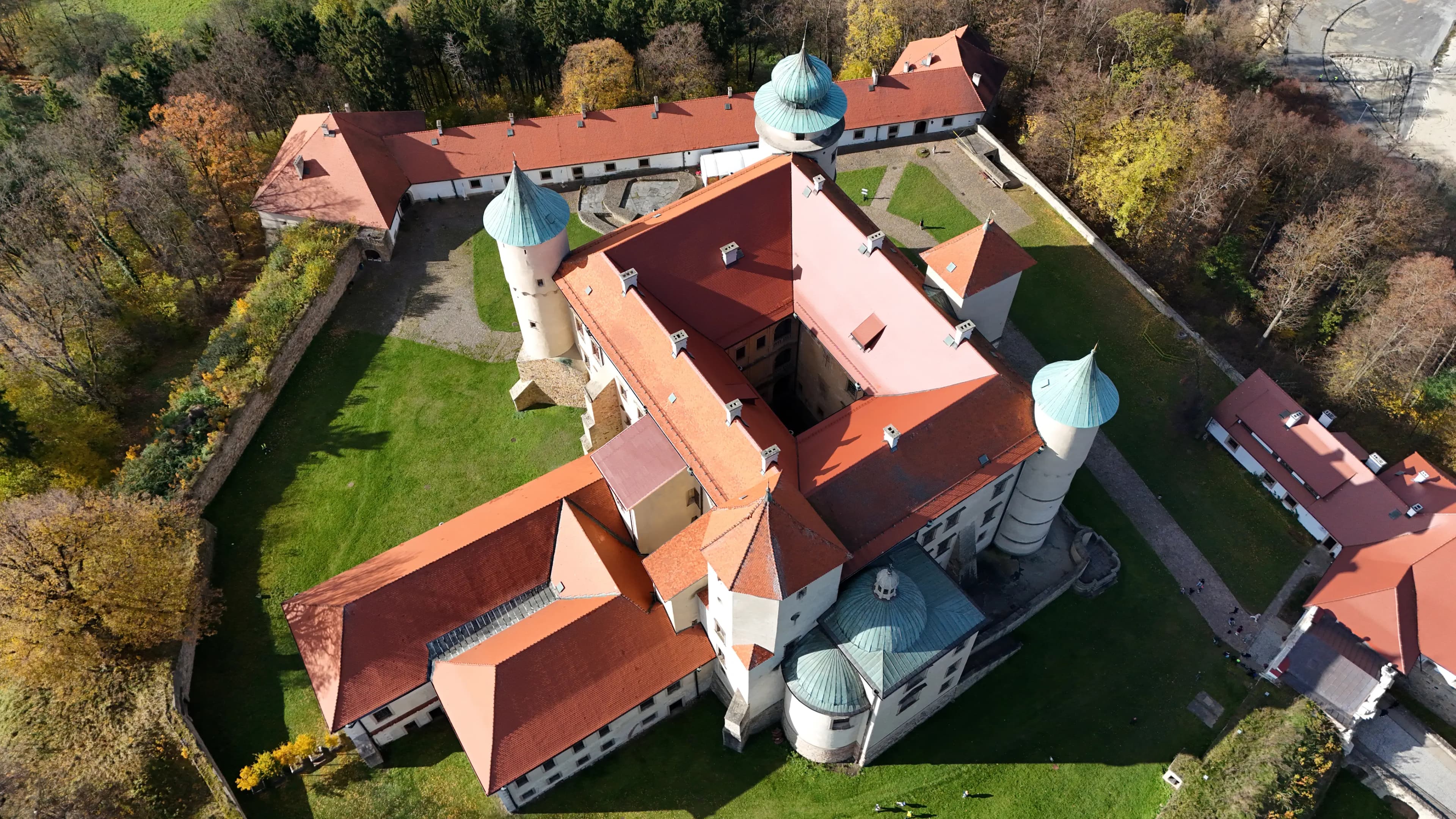 Aerial top-down view of Wiśnicz Castle showing its rectangular Renaissance courtyard layout with red-tiled roofs